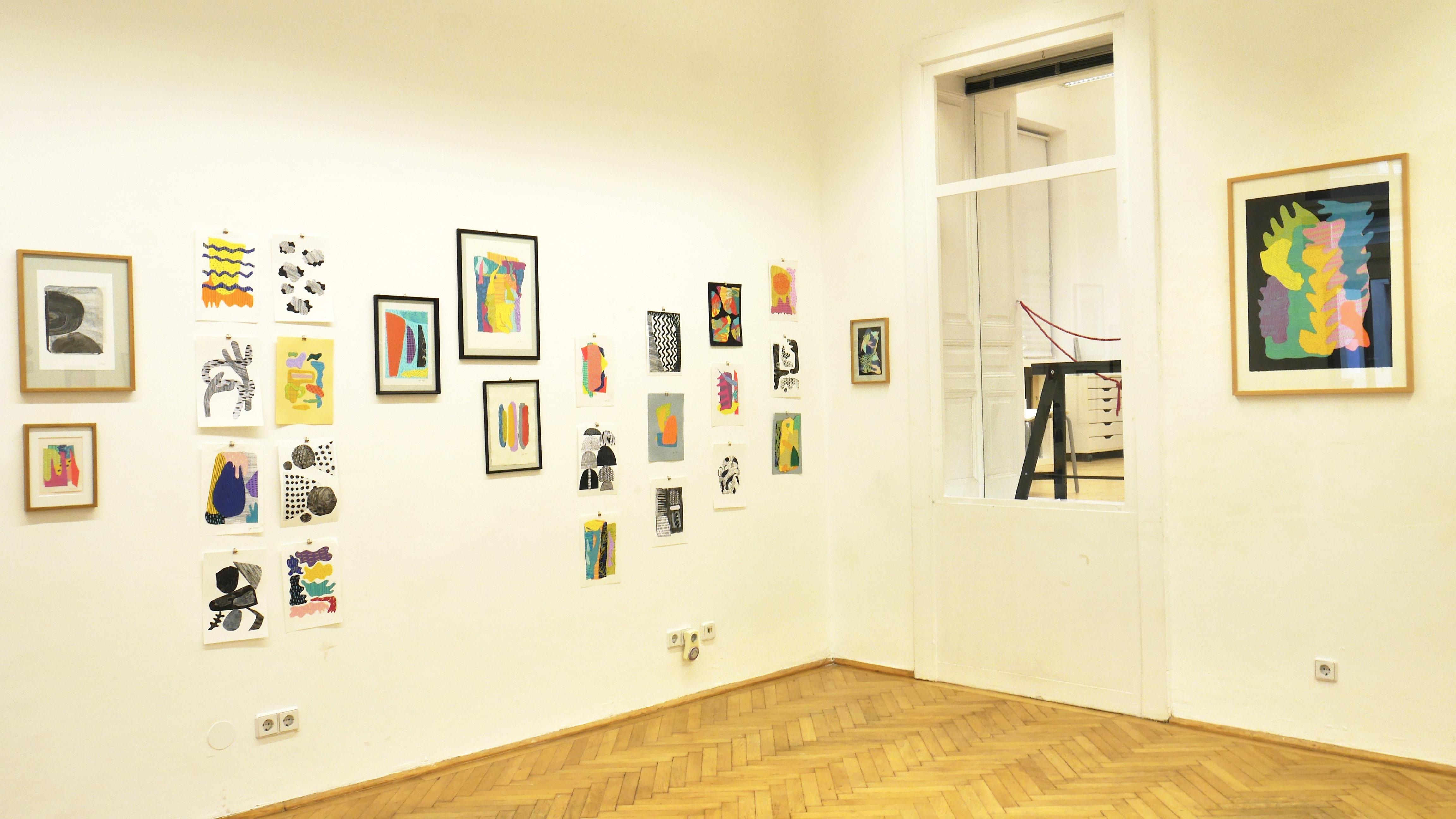 Exhibition room, hanging  collage artworks on the walls