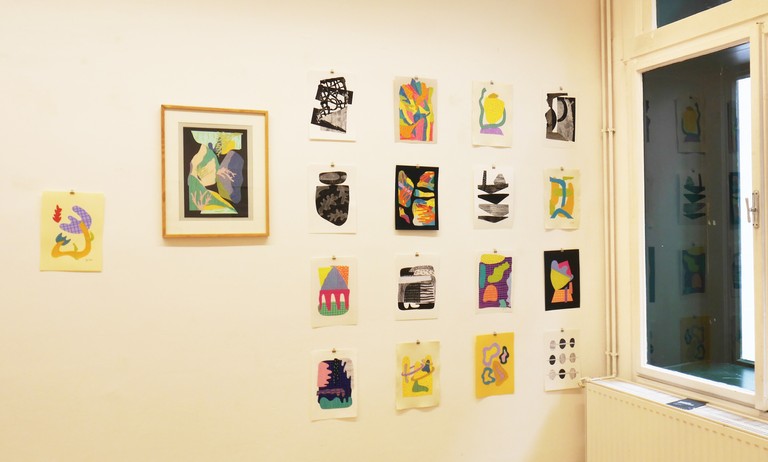 Hanging collage artworks on the wall