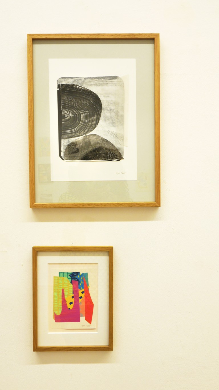 Hanging collage artworks on the wall