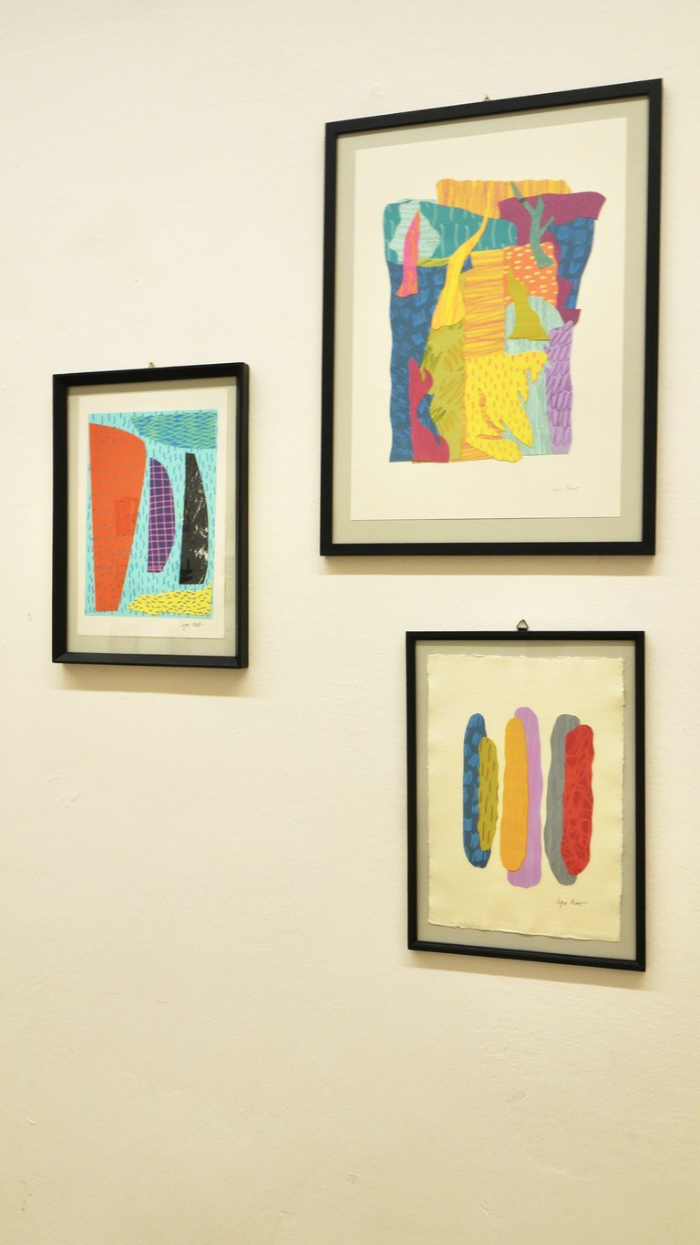 Hanging collage artworks on the wall