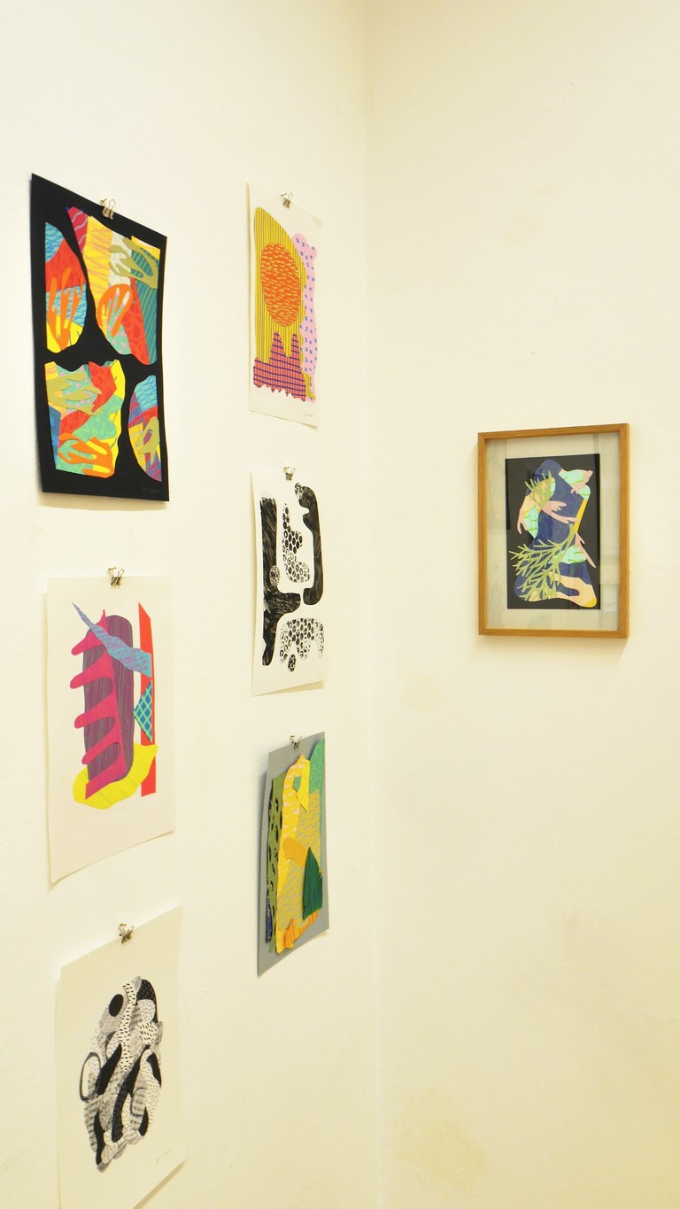 Hanging collage artworks on the wall