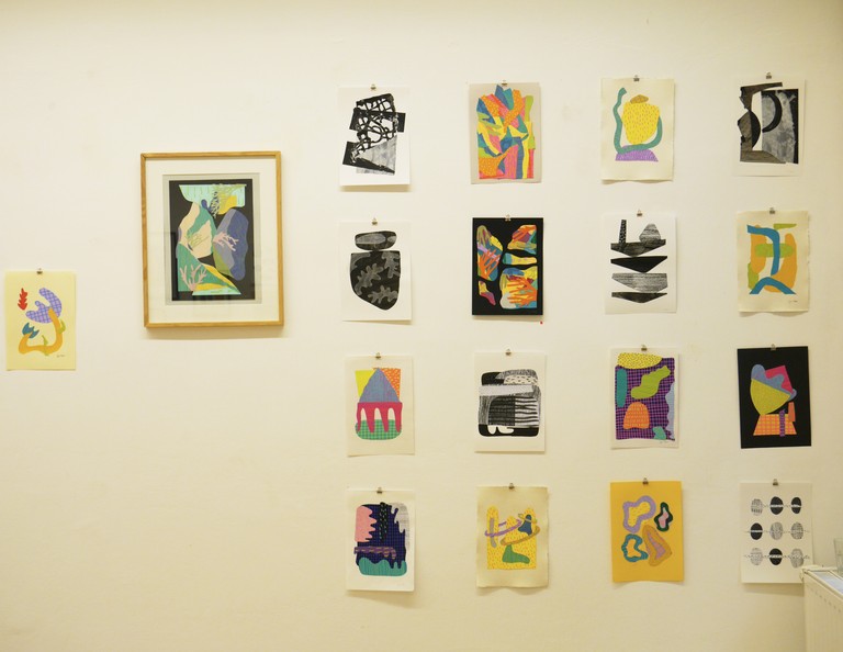Hanging collage artworks on the wall