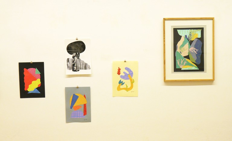 Hanging collage artworks on the wall