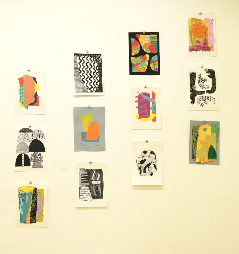 Hanging collage artworks on the wall