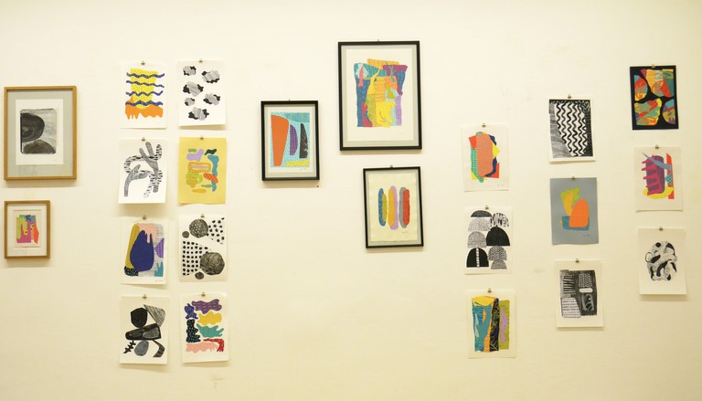 Hanging collage artworks on the wall