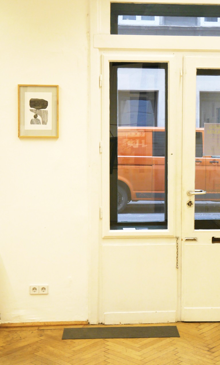Hanging collage artworks on the wall